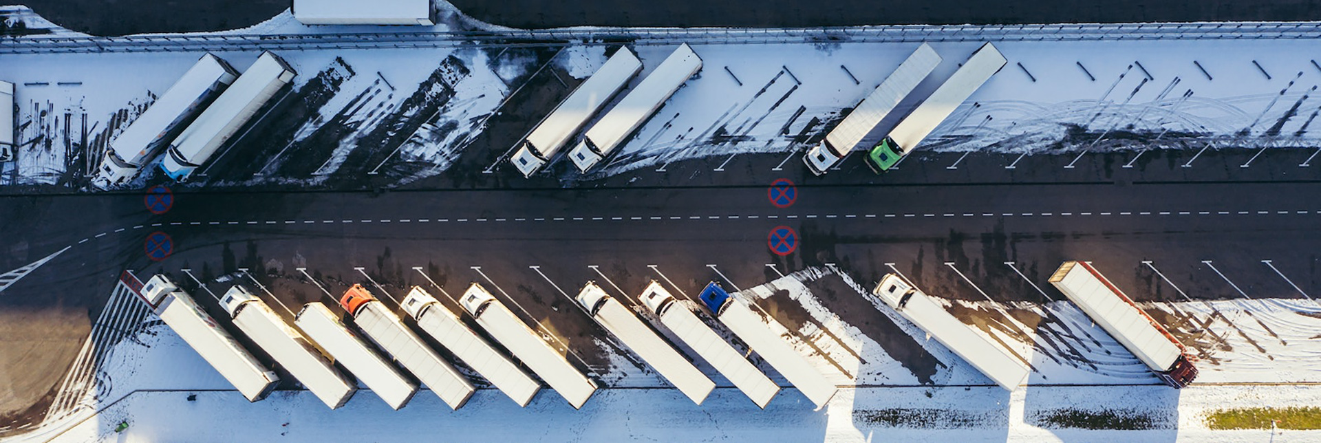 Trucks in the snow from above.
